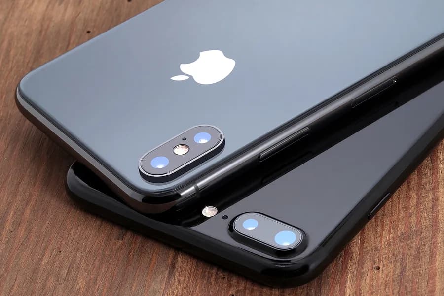 Dois iPhones cinza da Apple estão com a tela voltada para baixo.